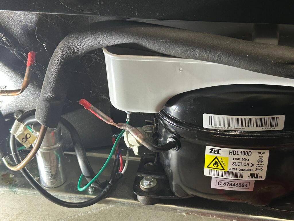 Refrigerator compressor with electrical wiring and cooling system components